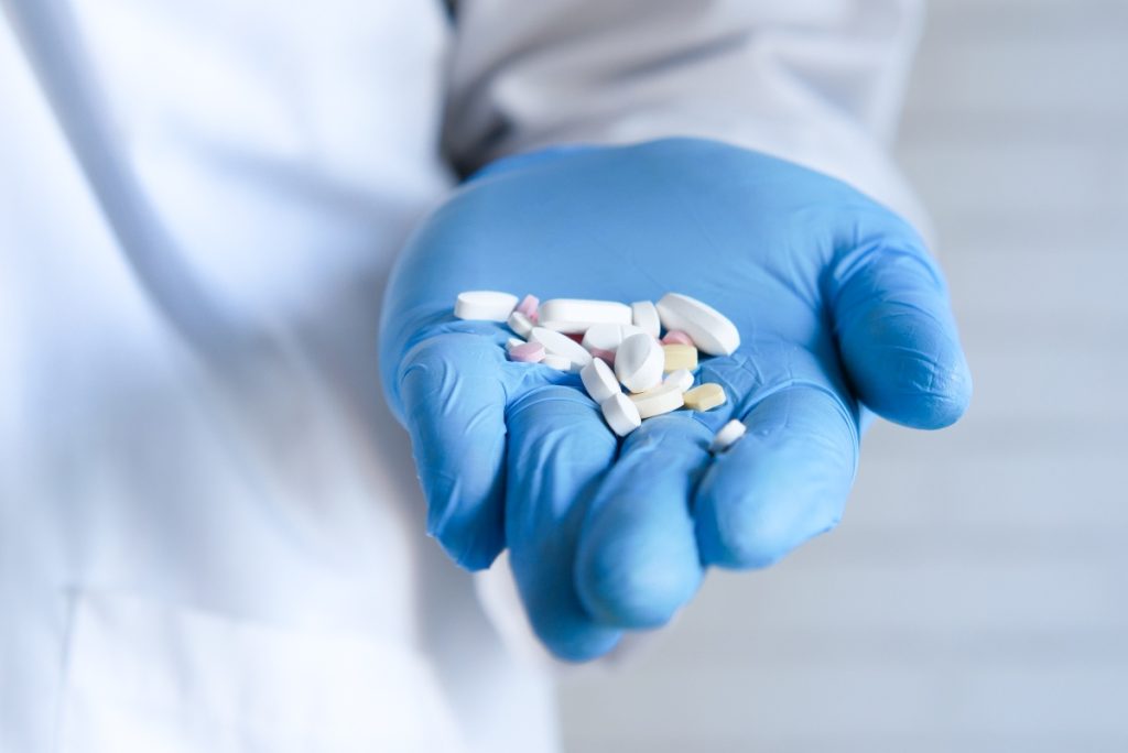 Doctor holding medical pills